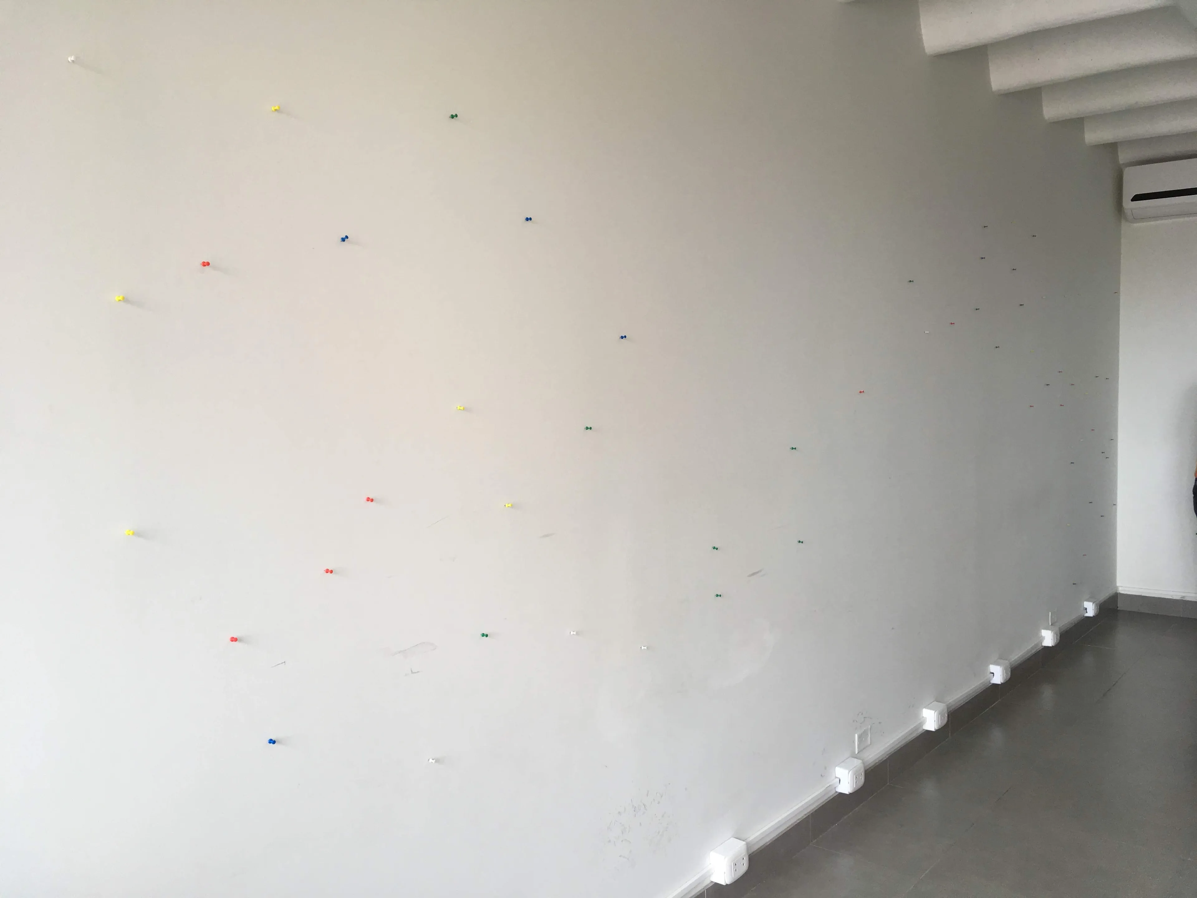 Wall full of colorful pins where each of the dots and lines should be.